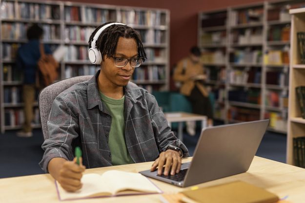 boy-studying-university-library